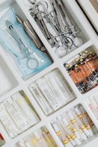 Close-up of syringes and medical supplies in a sterile laboratory setting, neatly arranged.